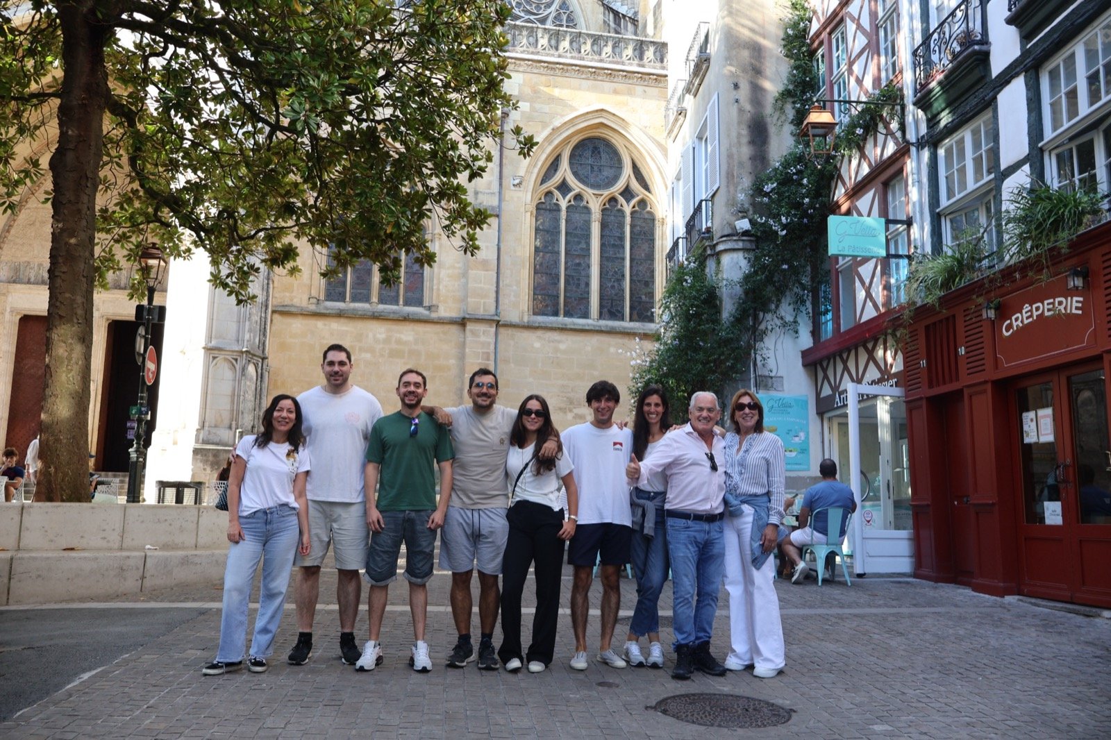 A group of travellers posing outside Bayonne Cathedral, in the old town