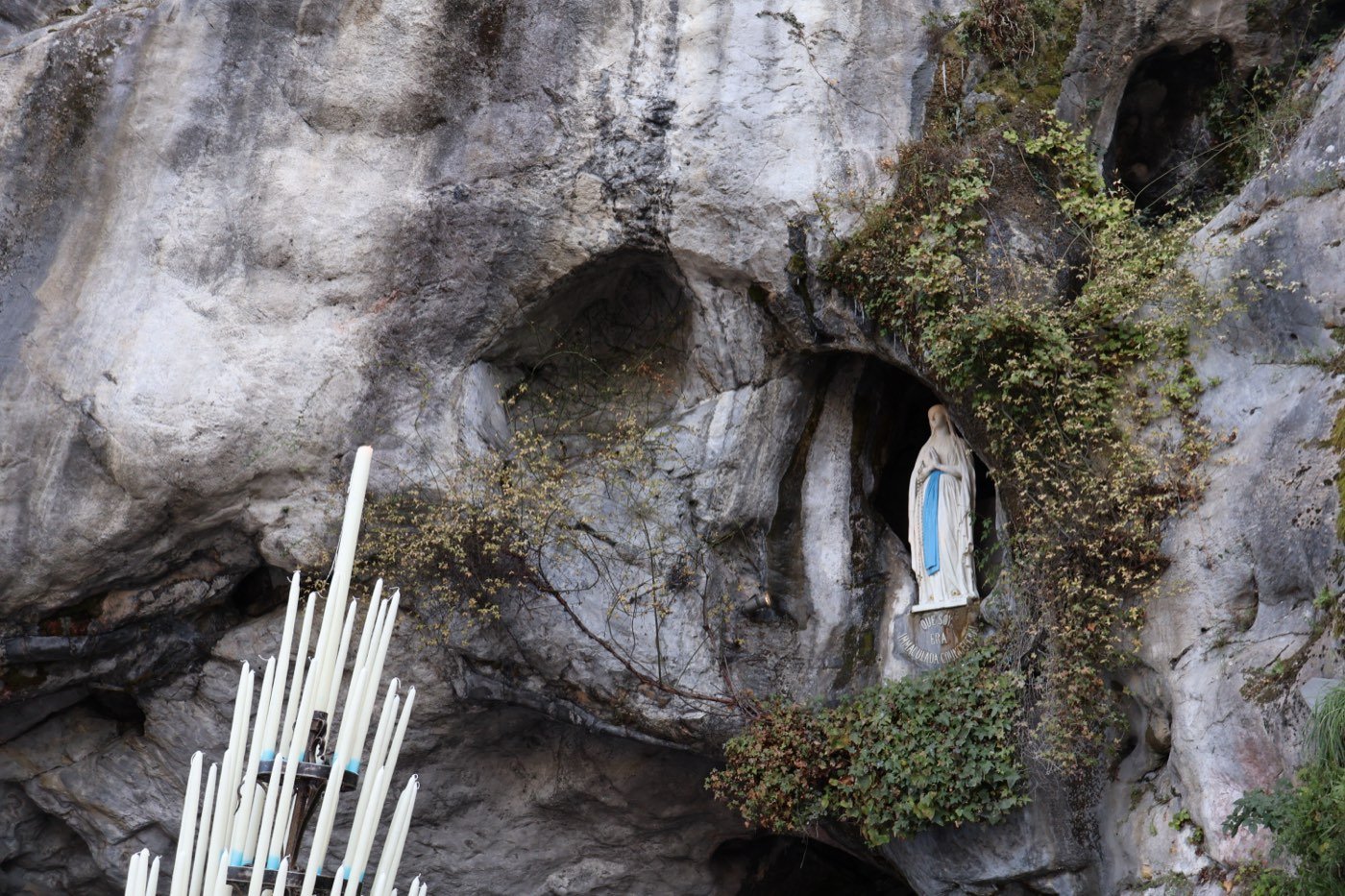 The Grotto of Massabielle, with the statue of the Virgin and votive candles