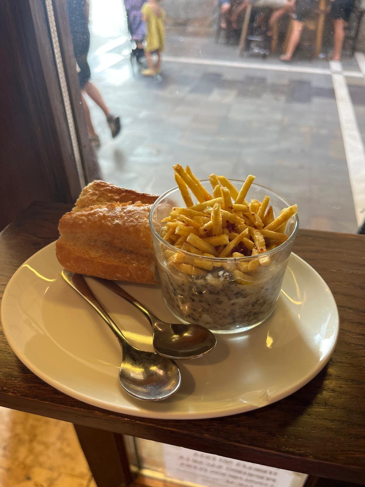 A pintxo plate by the window of a Pamplona café, overlooking the plaza