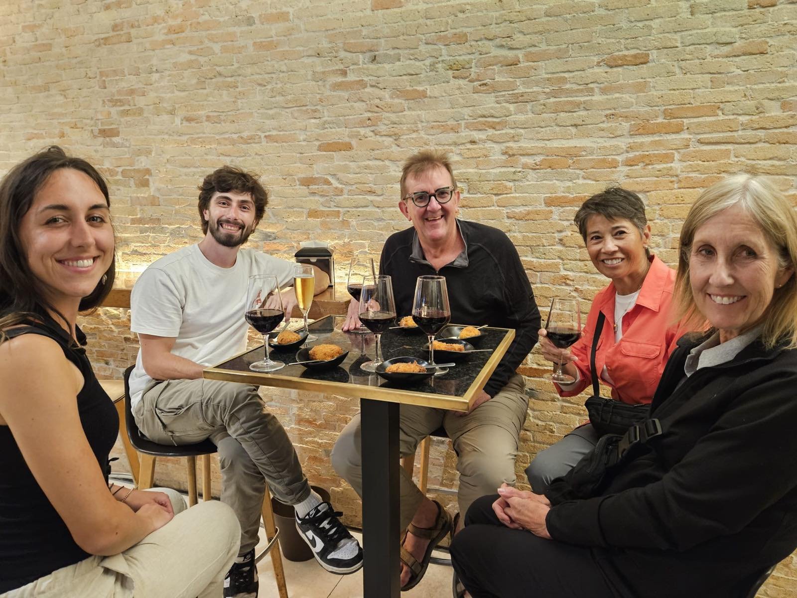Group sharing wine and croquetas at a Pamplona pintxo bar