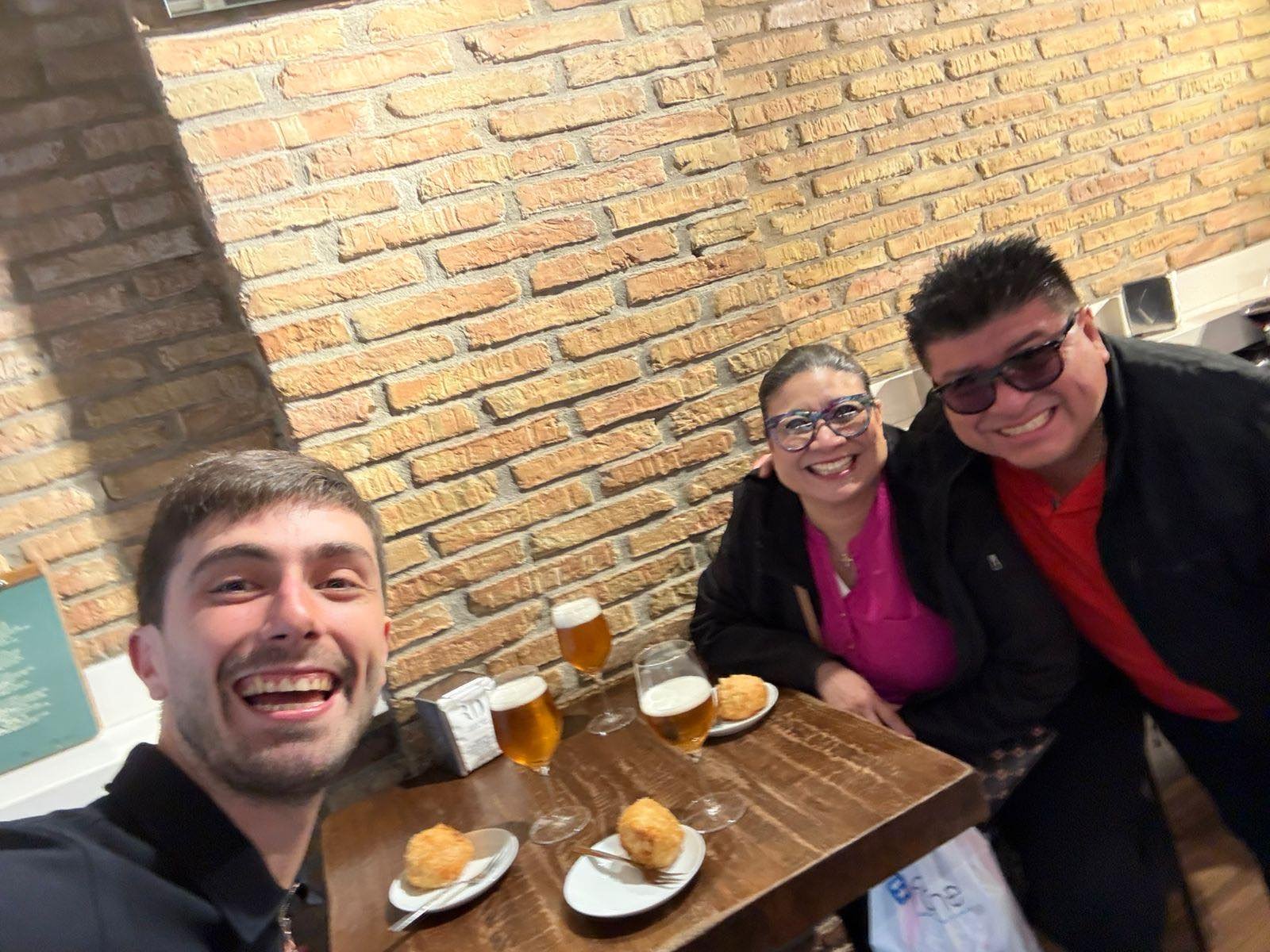 A group toasting with beer and pintxos at one of the tour stops