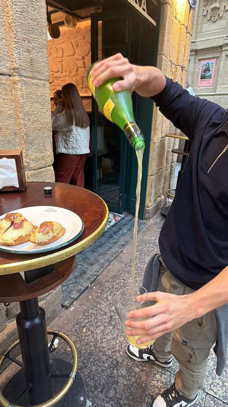 Cider poured txotx style on an Old Town street, San Sebastián