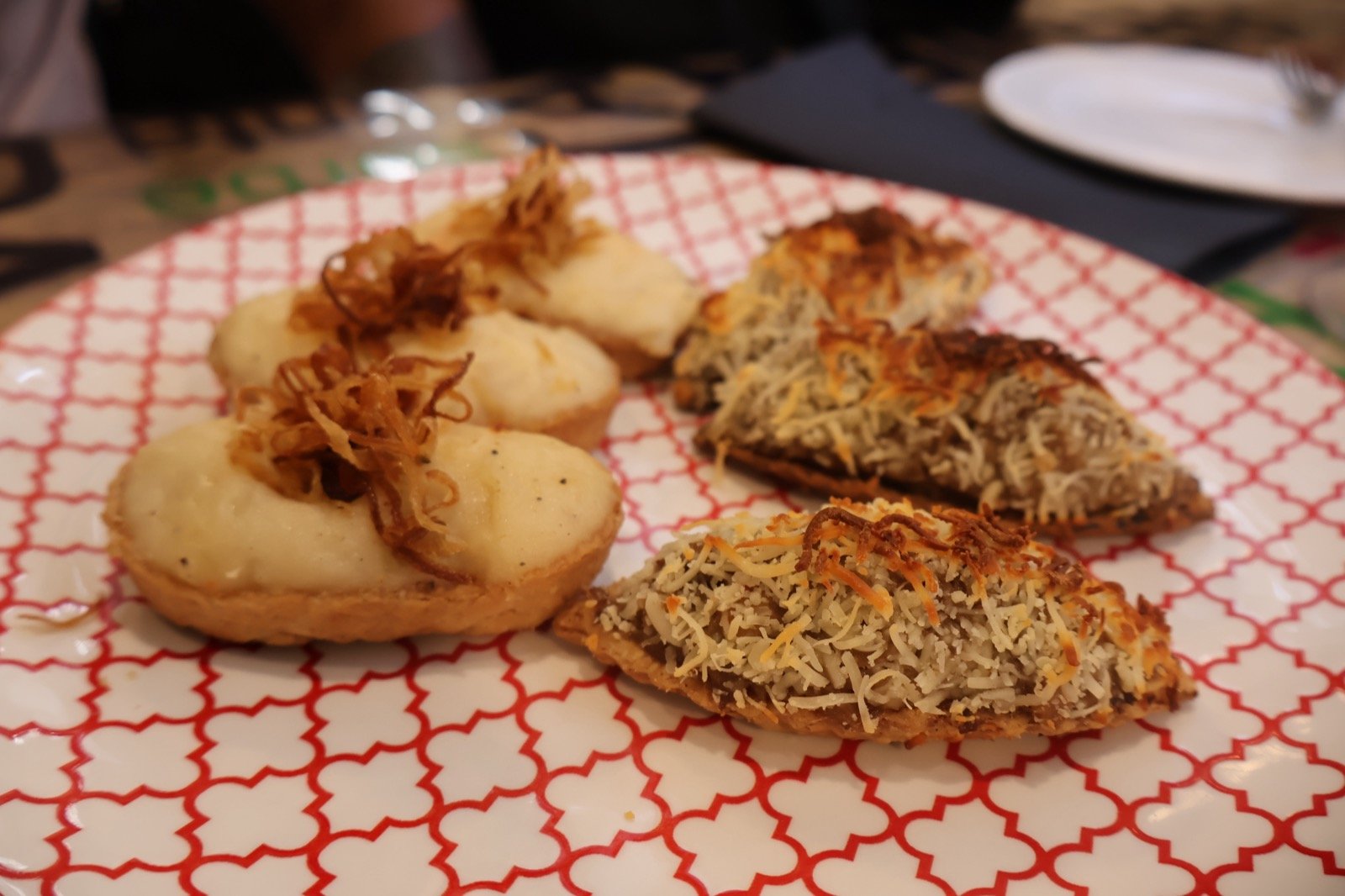 Close-up of tartlet and gratin pintxos on a plate